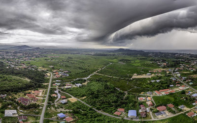 Aerial view of buildings in city against sky