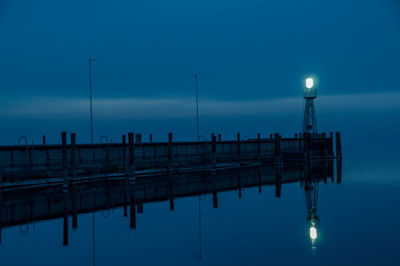 View of illuminated street light against blue sky