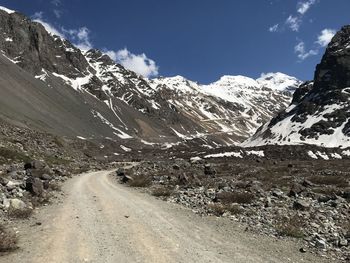 Road on snow covered mountain against sky