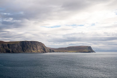 Scenic view of sea and mountains against sky