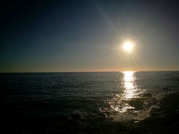 Scenic view of sea against clear sky at sunset