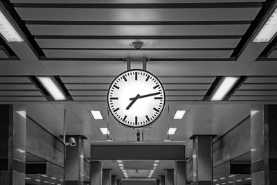 Low angle view of clock hanging on ceiling