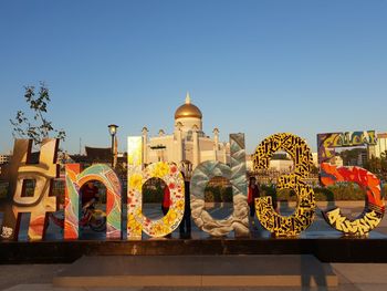 Graffiti on building against clear sky