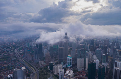 High angle view of modern buildings in city against sky