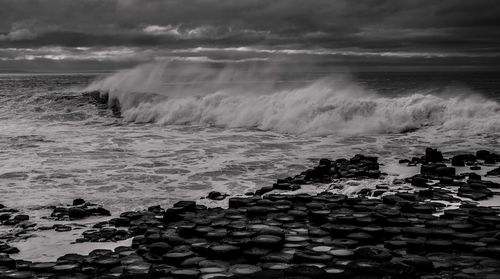 Scenic view of rocks in sea against sky