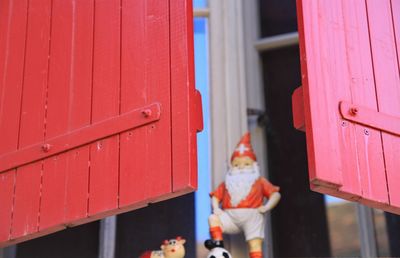 Low angle view of santa claus statue seen through window