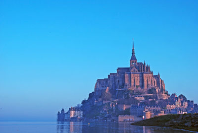 View of coastal town against blue sky