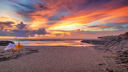 Scenic view of beach against sky during sunset