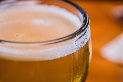 Close-up of beer glass on table