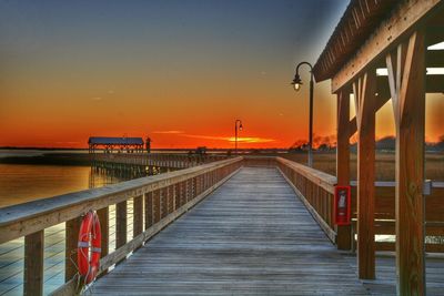 Pier on sea at sunset