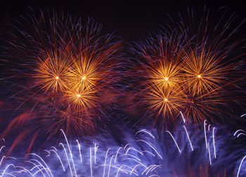 Low angle view of firework display at night