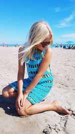 Full length of girl sitting on beach