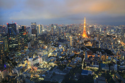 Illuminated cityscape against sky