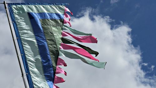 Low angle view of flag against cloudy sky