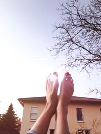 Low section of woman against clear sky