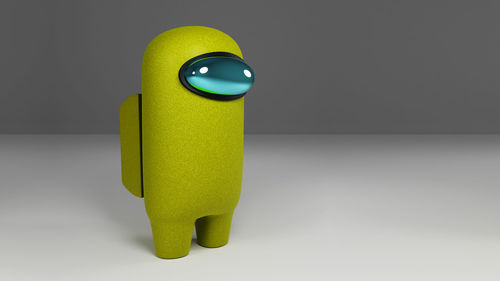 Close-up of yellow toy over white background