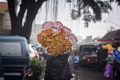 Man with umbrella on street during rainy season