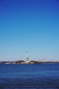 View of sea against clear blue sky