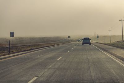 Cars on highway against clear sky