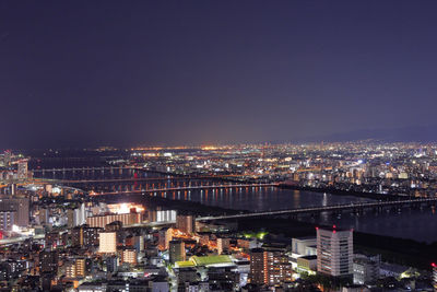 High angle view of illuminated buildings against sky at night