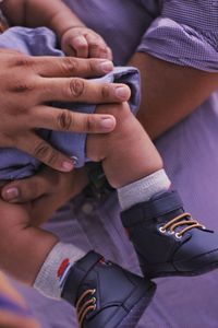 Midsection of couple holding hands