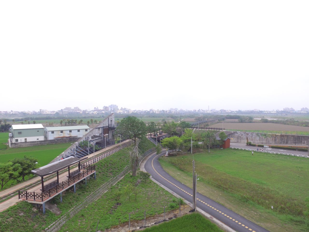 HIGH ANGLE VIEW OF TRAIN ON FIELD AGAINST SKY