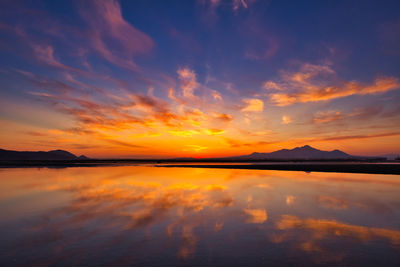 Scenic view of lake against romantic sky at sunset