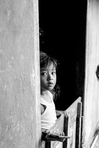Portrait of boy looking through window