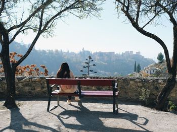 Woman admiring the alhambra on bench