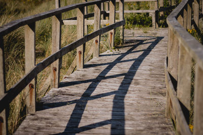 Shadow of railing on footpath