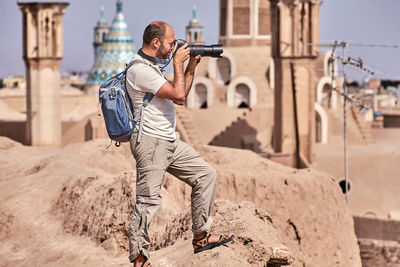 Man with camera at historic place