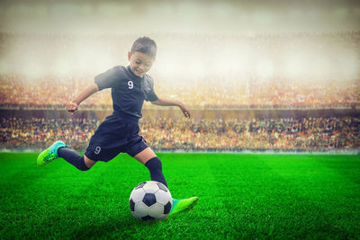 Boy playing soccer on field