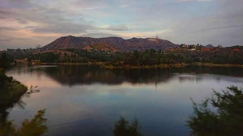 Scenic view of lake and mountains against sky