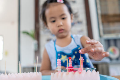 Cute little girl concentrated playing at kindergarten.