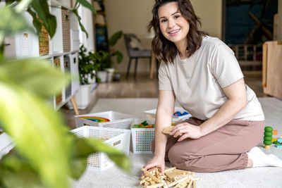 Portrait of young woman holding food at home