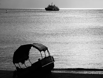 Boat sailing in sea against sky