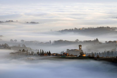 Scenic view of levizzano castle with sea of clouds during foggy weather