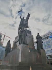 Low angle view of statue against cloudy sky