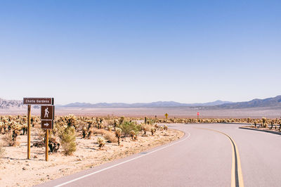 Road against clear blue sky