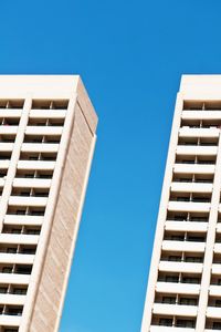 Low angle view of buildings against clear blue sky