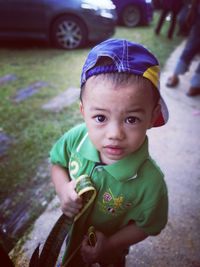 Portrait of cute boy holding sunglasses