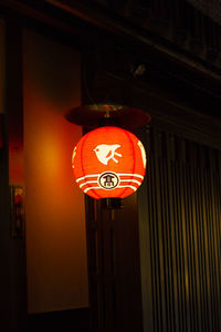 Low angle view of illuminated lanterns hanging on building