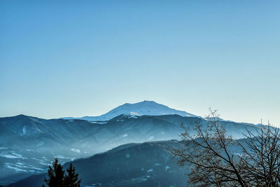 Scenic view of mountains against blue sky