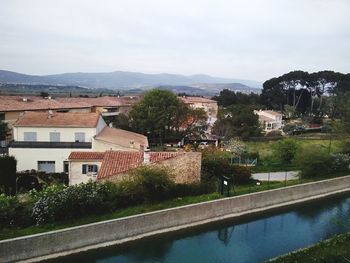 Buildings in town against sky