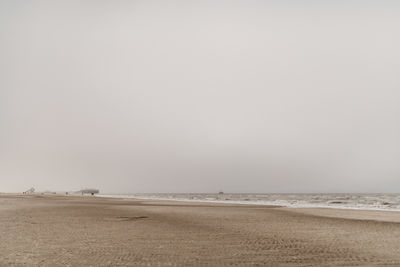 Scenic view of beach against clear sky