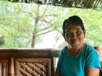 Portrait of woman sitting on bench