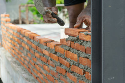 Man working on wood against wall