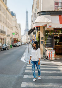 Rear view of woman walking on street in city