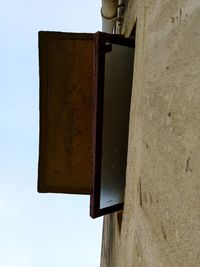 Low angle view of weathered wall against clear sky