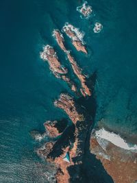 Directly above shot of rocks by sea